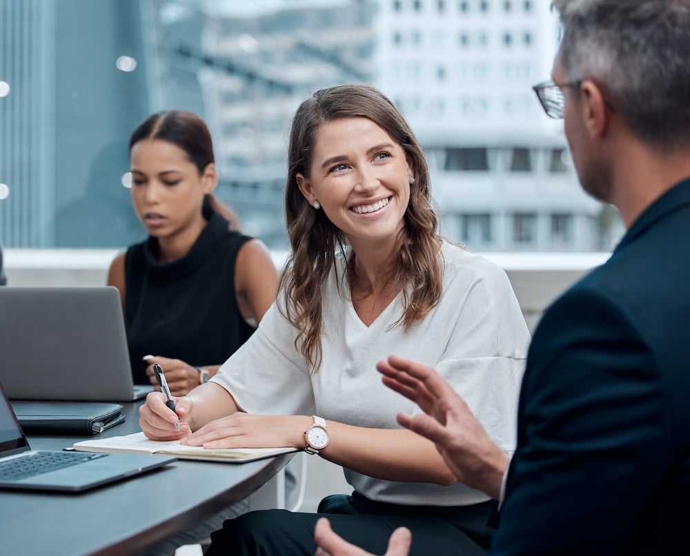 Diversity, professional woman and meeting in office for collaboration, teamwork and brainstorming with laptop. Technology, business people and group in corporate workplace for strategy and research.